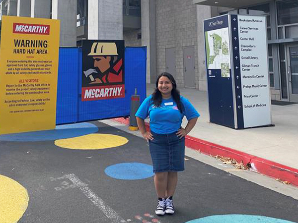 Triton Student in front of Construction Site